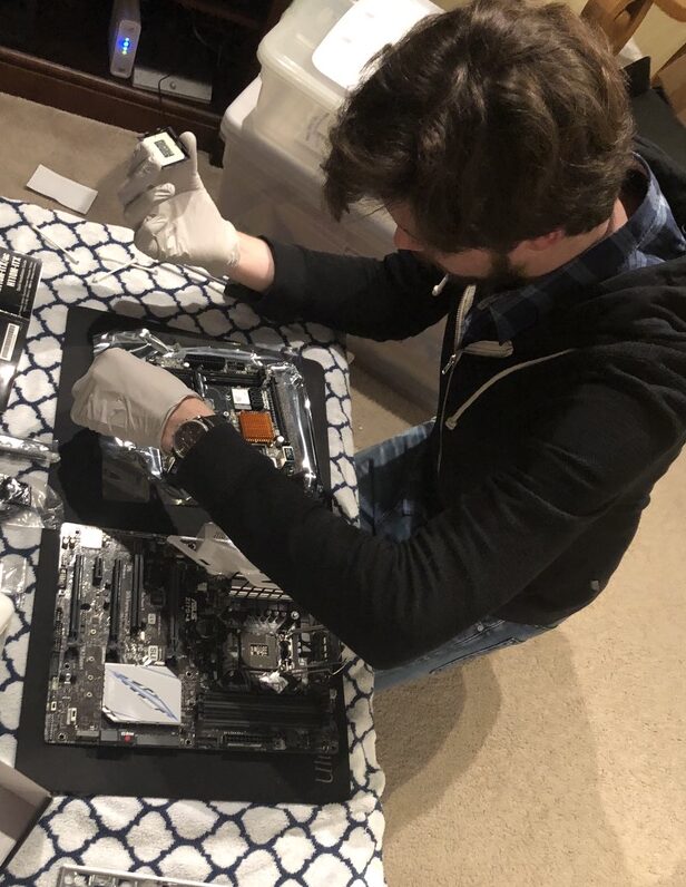 I am pictured here taking apart my Windows PC to upgrade the motherboard. 